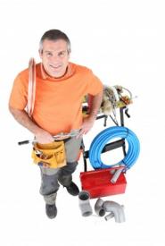 plumber in Lewisville Texas poses with equipment