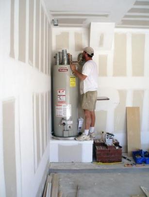 Plumbing professional installs a 40 gallon storage water heater